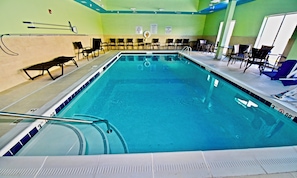 A swimming pool with a diving board, pool rules signs, and lounge chairs. - Holiday Inn Express & Suites Perryville by IHG (Perryville)