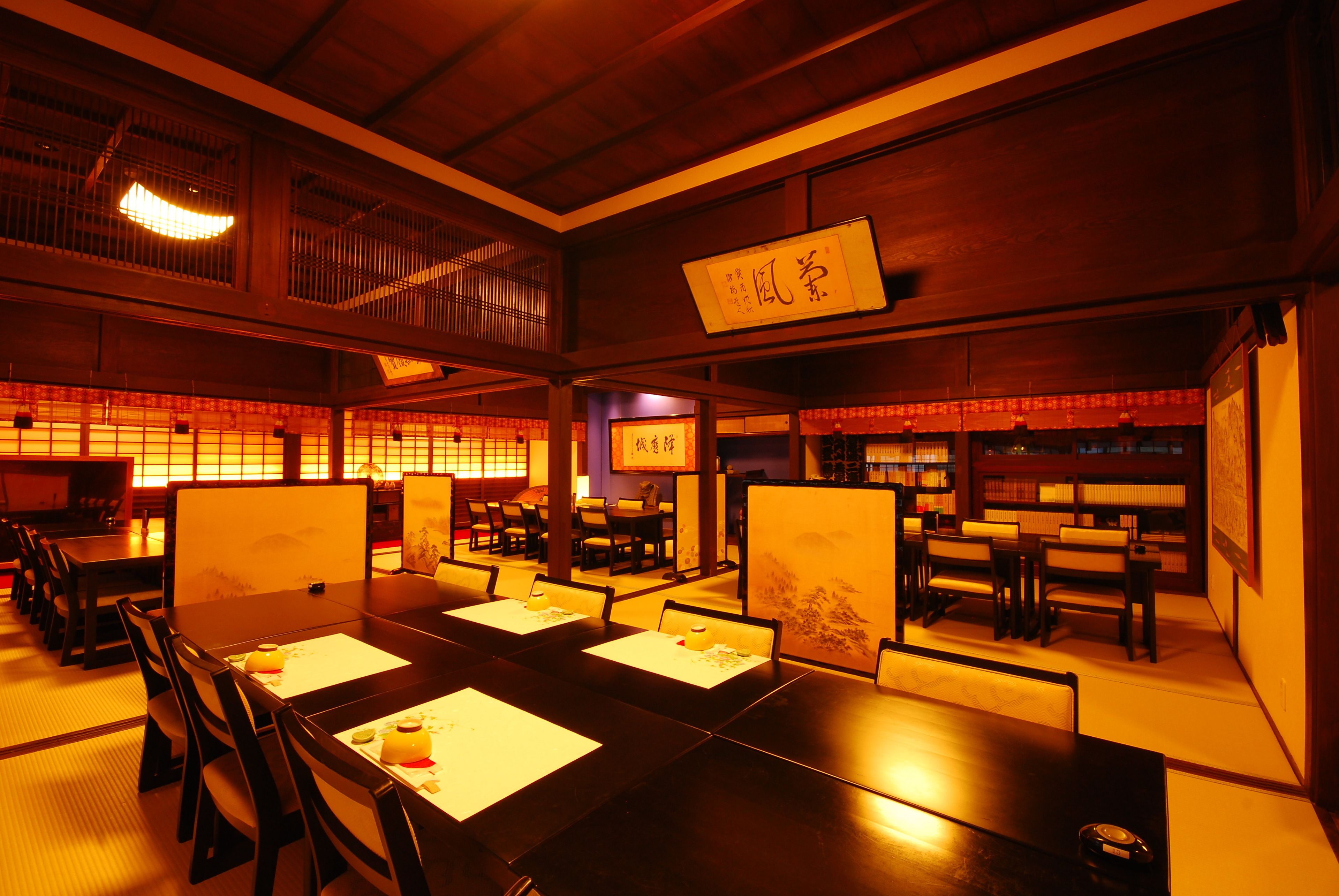A traditional Japanese restaurant with tatami mat seating, low wooden tables, and shoji screens.