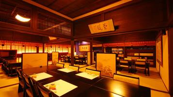 A traditional Japanese restaurant with tatami mat seating, low wooden tables, and shoji screens.