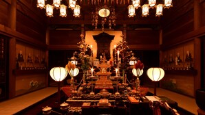 A traditional Japanese shrine with a central altar, surrounded by various ritual items and lanterns. - Koyasan Syukubou Fudouin (Koya)
