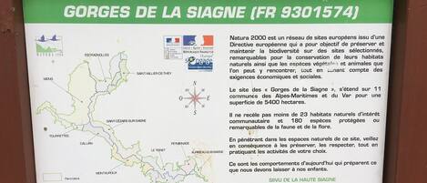 A signboard with information about Natura 2000, specifically the Gorges de la Siagne in France.