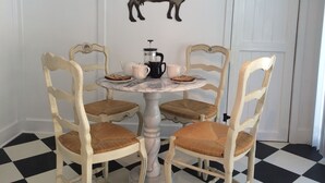 A dining table with four chairs, a milk can, and a coffee pot. - Chic Historic Cottage in the Heart of 3 Rivers-close to SNP, Hot Tub, Love dogs! (Three Rivers)