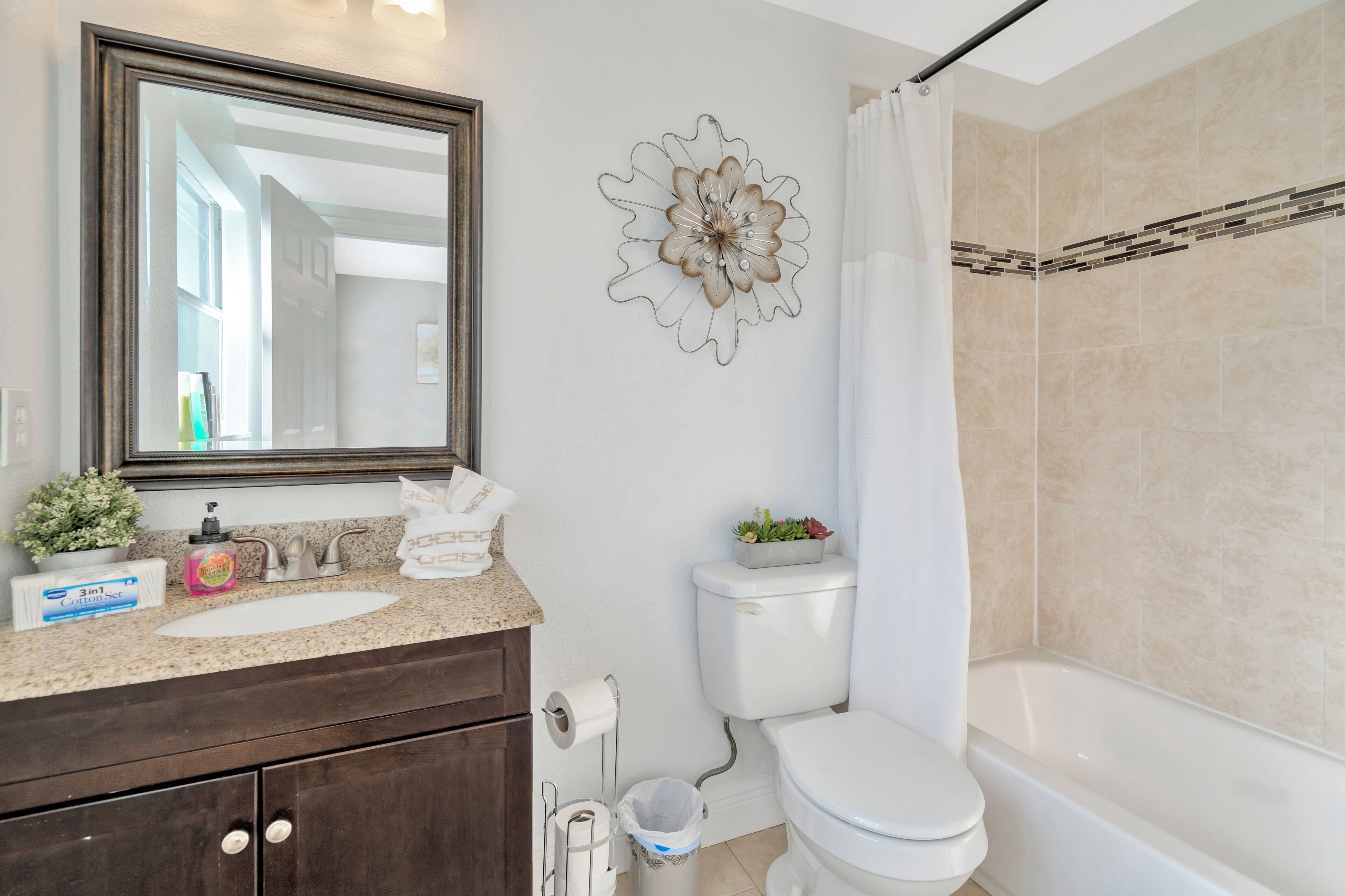A bathroom with a sink, toilet, and bathtub.