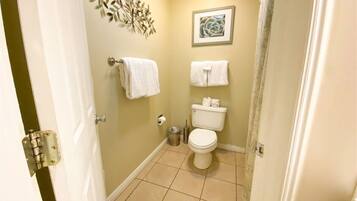 A bathroom with a toilet, a sink, and a shower curtain.