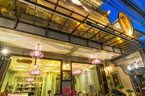 A restaurant with a sign reading "Food Drink Fresh Coffee" and a decorative ceiling with hanging lanterns. - U Residence Hotel (Krabi)