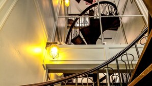A spiral staircase with metal railings and wooden steps, leading to an upper level. - U Residence Hotel (Krabi)