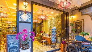 A hotel lobby with a reception desk, a chalkboard with ticket information, and a bicycle. - U Residence Hotel (Krabi)