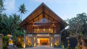 A modern building with a triangular roof and large windows. - Sagara Candidasa by AHM (Karangasem)