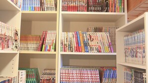 A library with multiple shelves filled with books. - 2500 Comics Room (Tokyo)