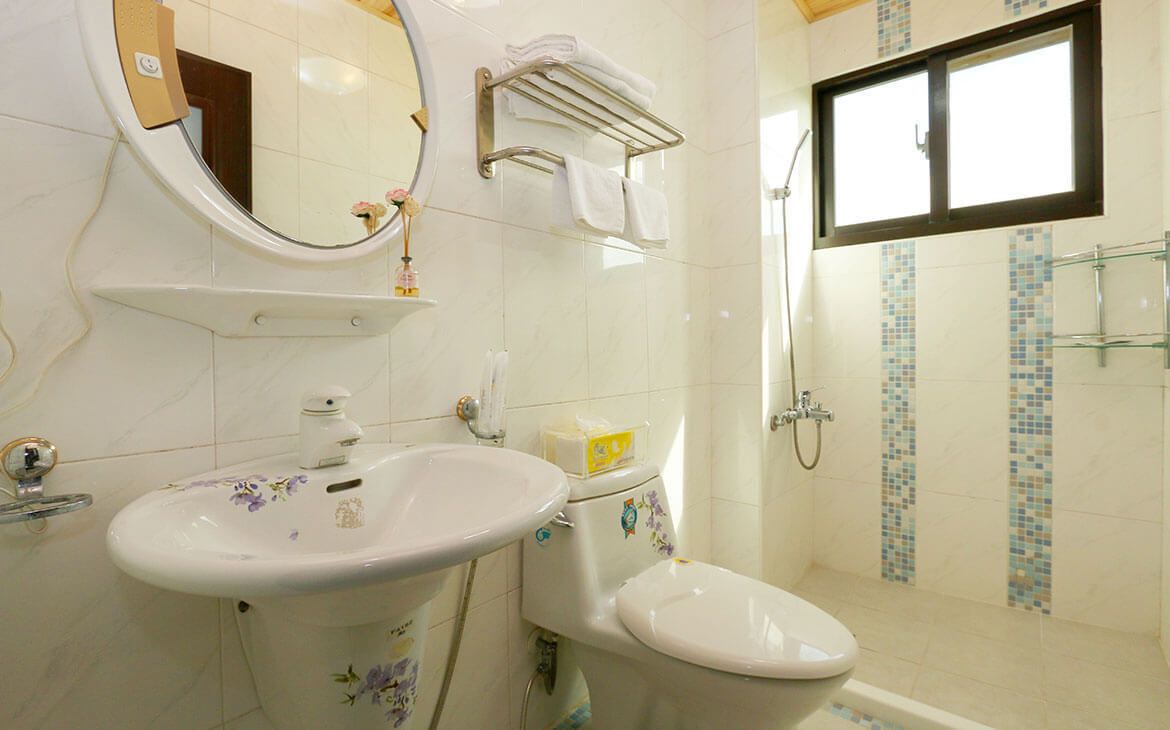 A bathroom with a sink, toilet, and shower.