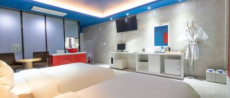 A modern hotel room with a large bed, a small desk, a TV, and a red cabinet.