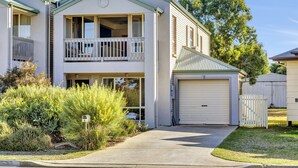 A two-story residential building with a balcony, a garage, and a mailbox. - The Lighthouse (Port Willunga)