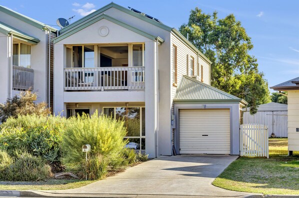 A two-story residential building with a balcony, a garage, and a mailbox. - The Lighthouse (Port Willunga)