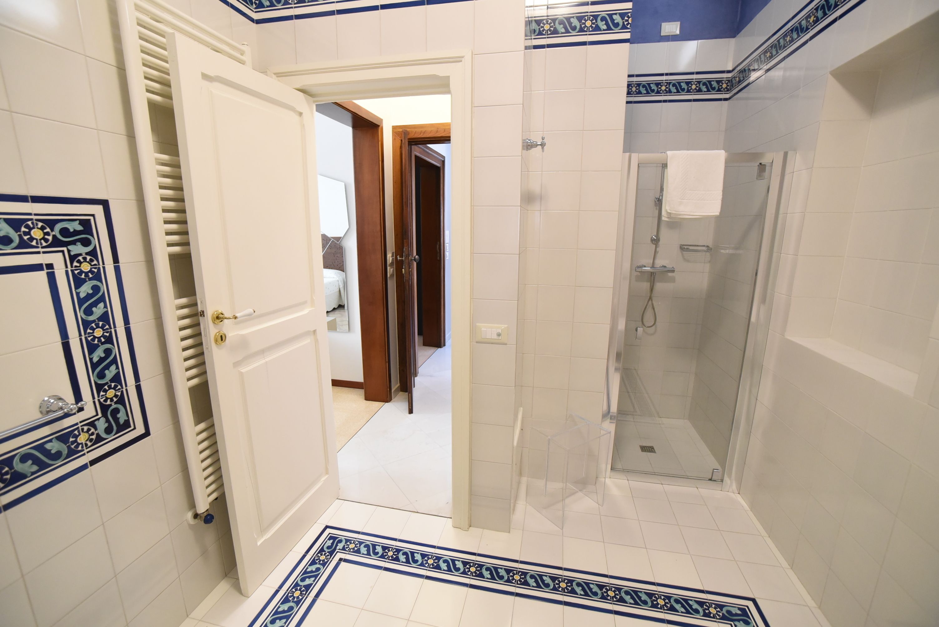 A bathroom with a shower, a toilet, and a sink.