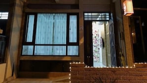A multi-story building with large windows and a balcony on the upper floor. - Chance Encounter (Luodong)