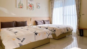A hotel room with two beds, a wooden headboard, a bedside table, and a large window with sheer curtains. - Chance Encounter (Luodong)