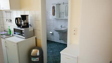 Fridge, microwave, coffee/tea maker, cookware/dishes/utensils