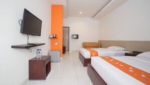 A hotel room with a bed, bedside tables, a TV, a desk, and a chair. - Adikara Renon (Denpasar)