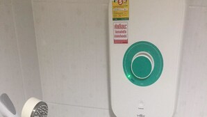 A shower unit with a handheld showerhead and a wall-mounted control panel. - SP Place (Chachoengsao)