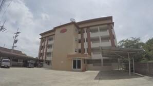 A multi-story building with a central entrance, a covered parking area, and a satellite dish on the roof. - SP Place (Chachoengsao)