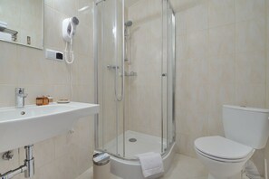 A modern bathroom with a glass-enclosed shower, a white sink, and a toilet. - Hotel Centrum Sosnowiec (Sosnowiec)