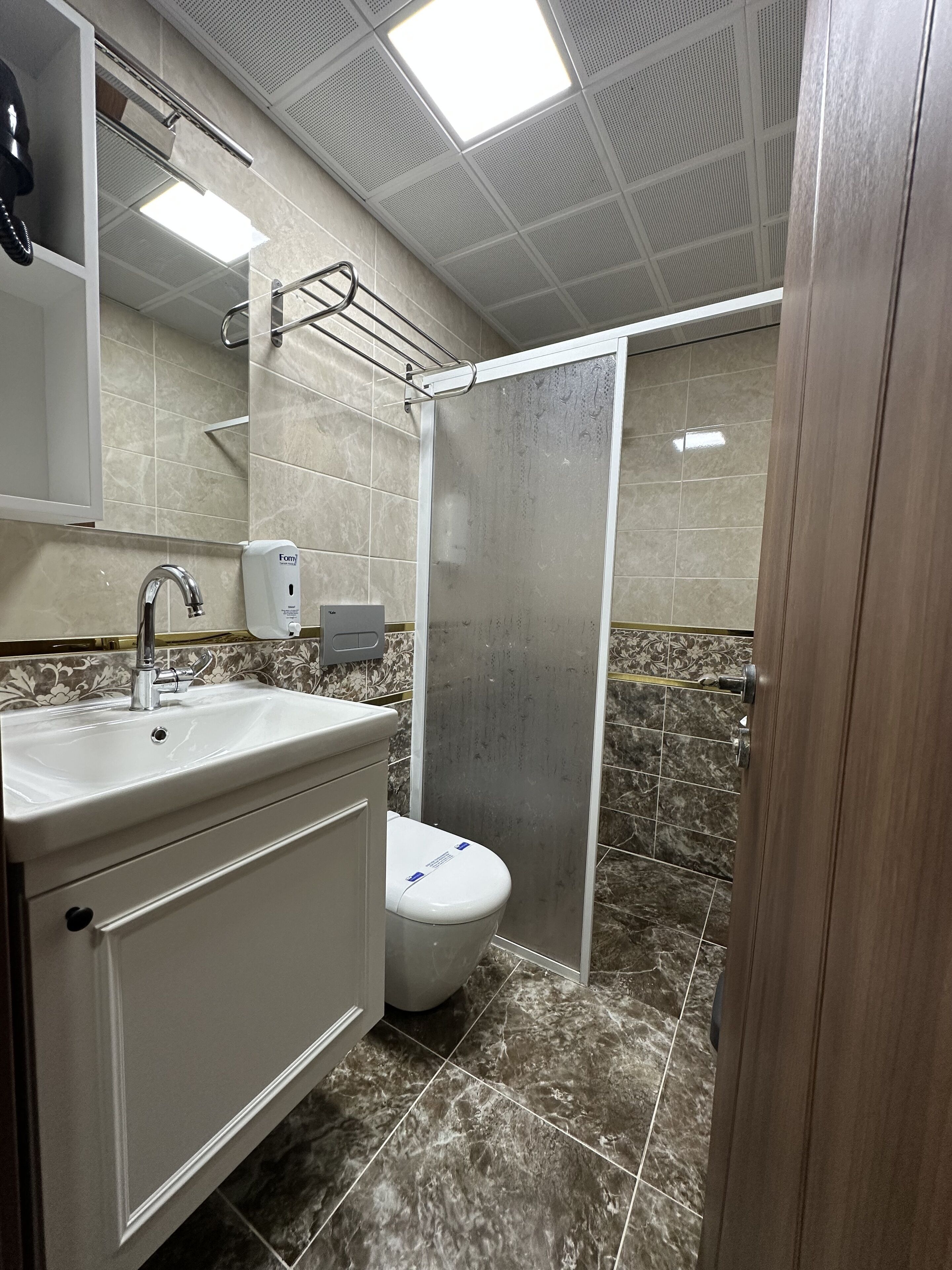 luxury triple room | bathroom | shower, hair dryer, slippers, towels