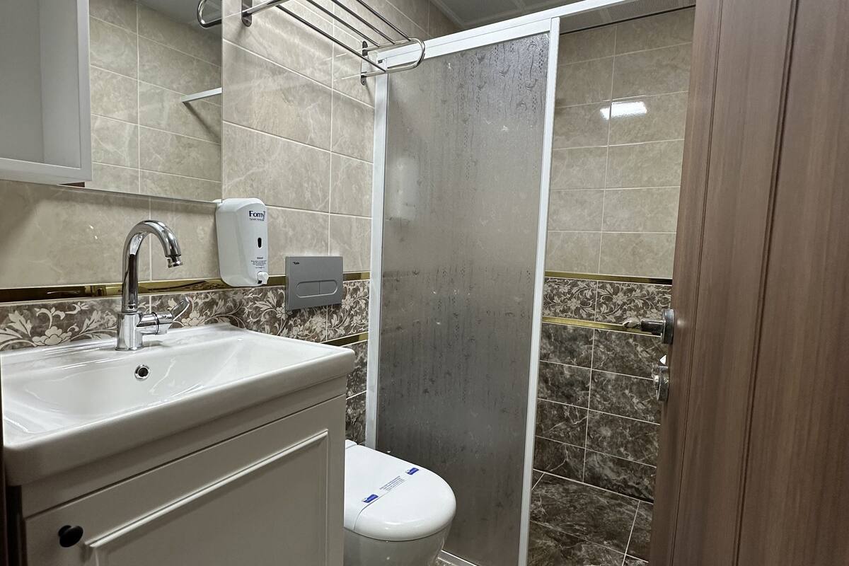 luxury triple room | bathroom | shower, hair dryer, slippers, towels