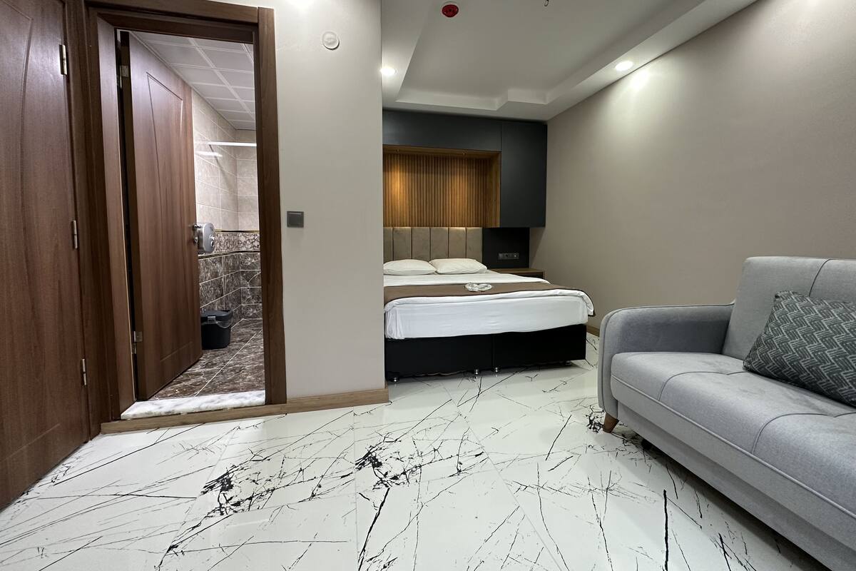 premier triple room | bathroom | shower, hair dryer, slippers, towels