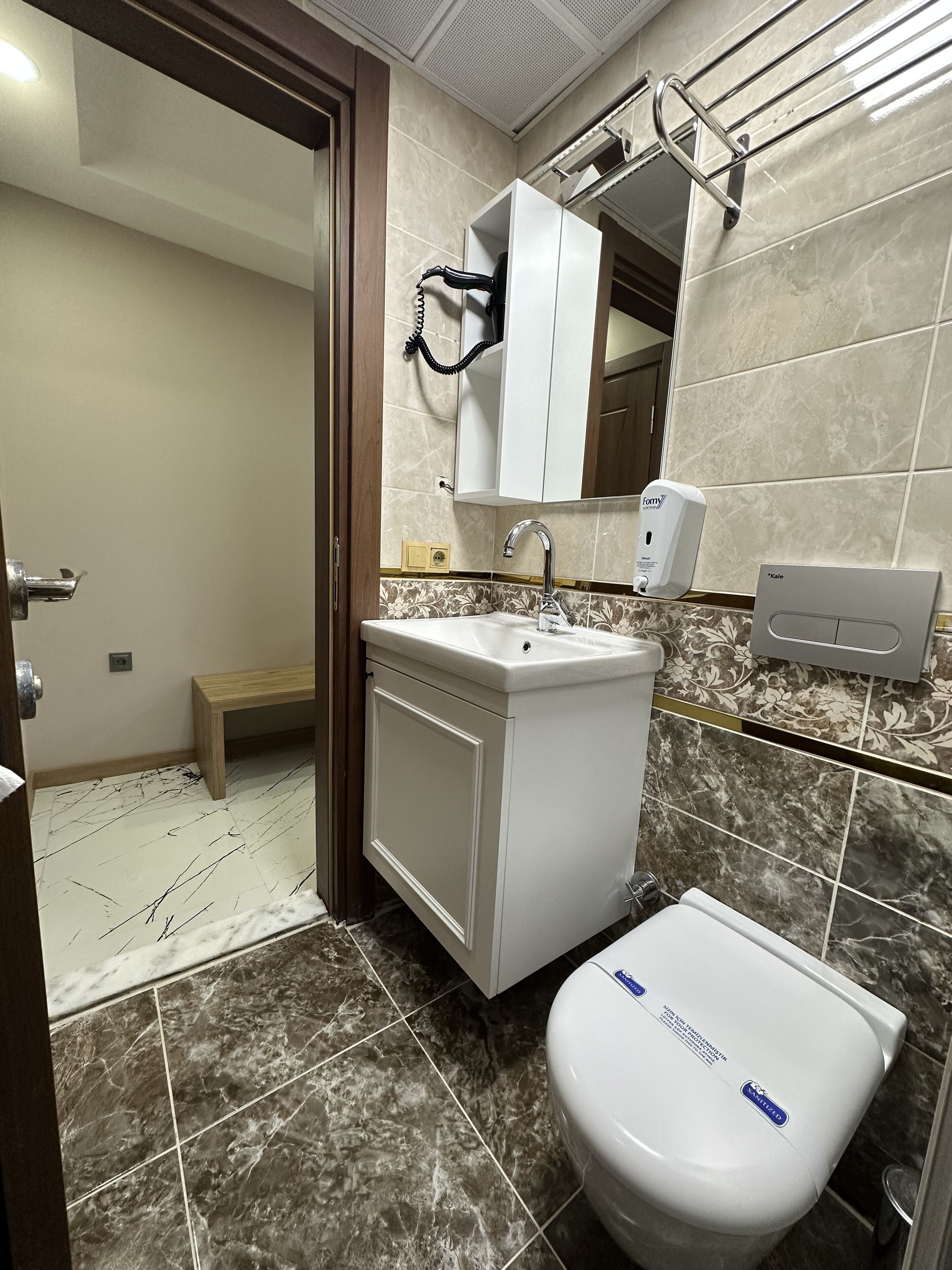 shower, hair dryer, slippers, towels