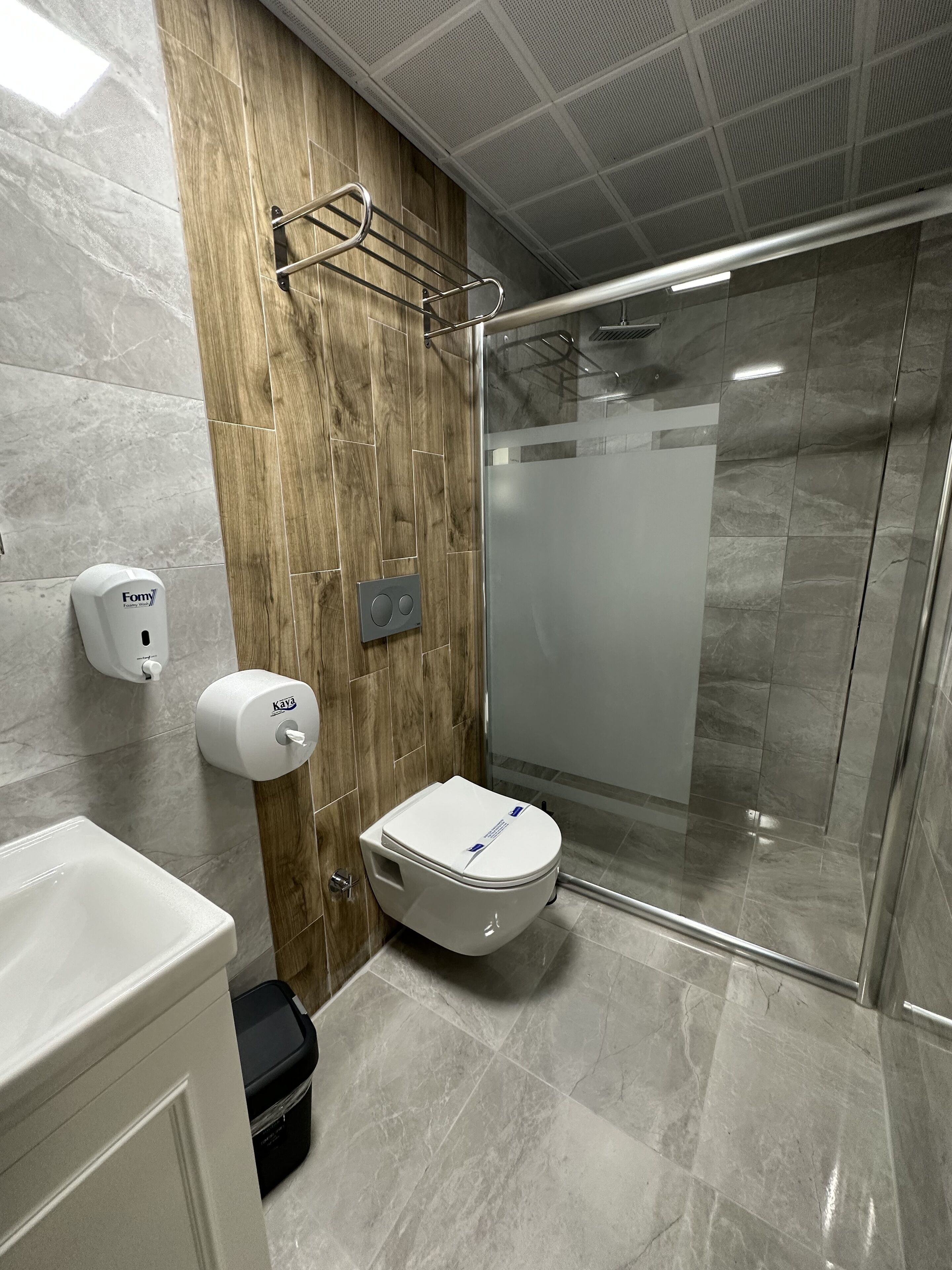 superior suite | bathroom | shower, hair dryer, slippers, towels