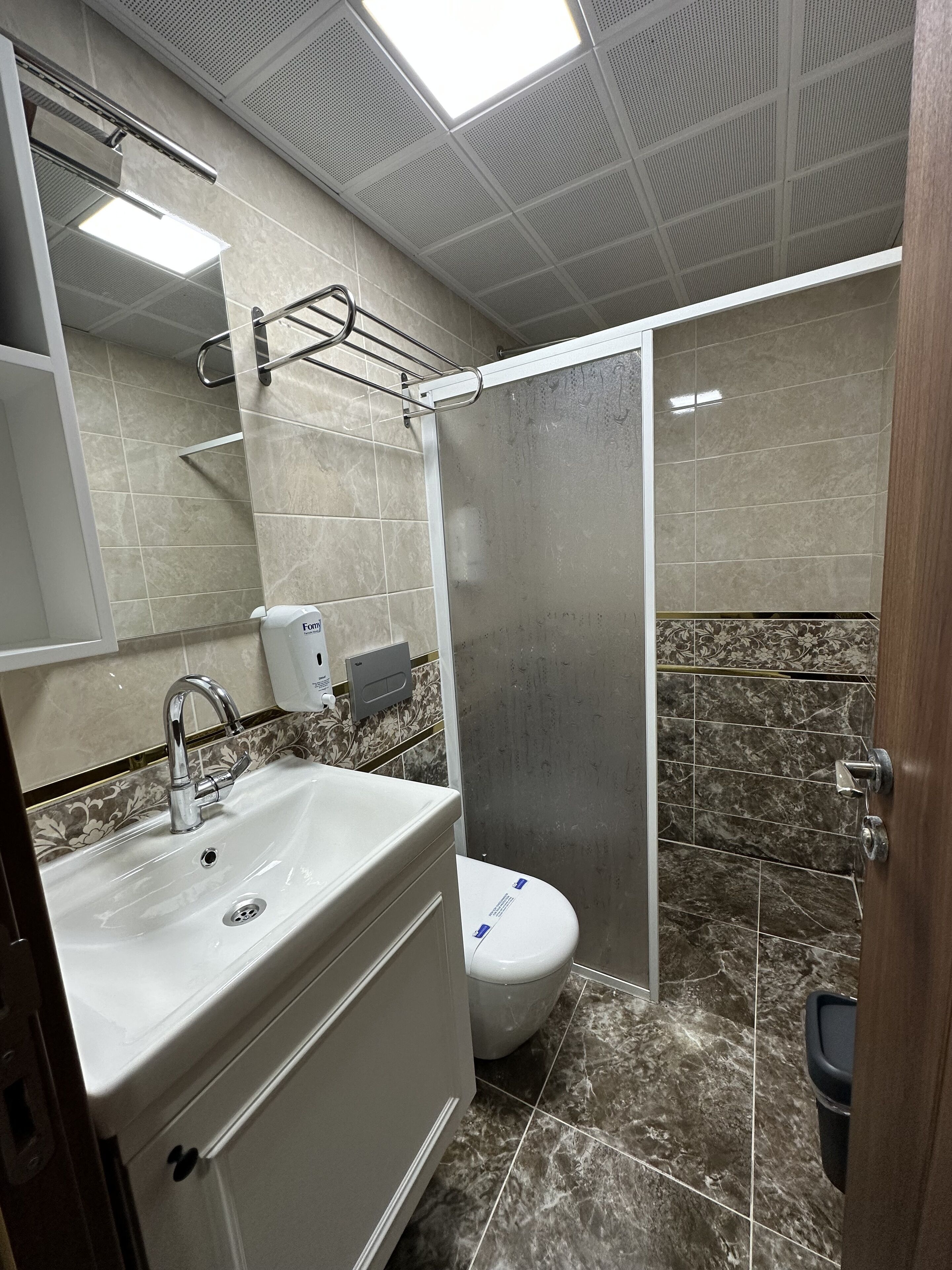 shower, hair dryer, slippers, towels