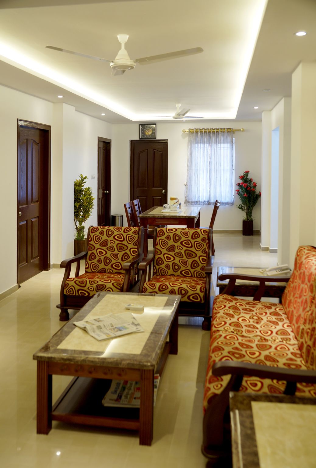 single cot room with shared bathroom | living area | flat-screen tv