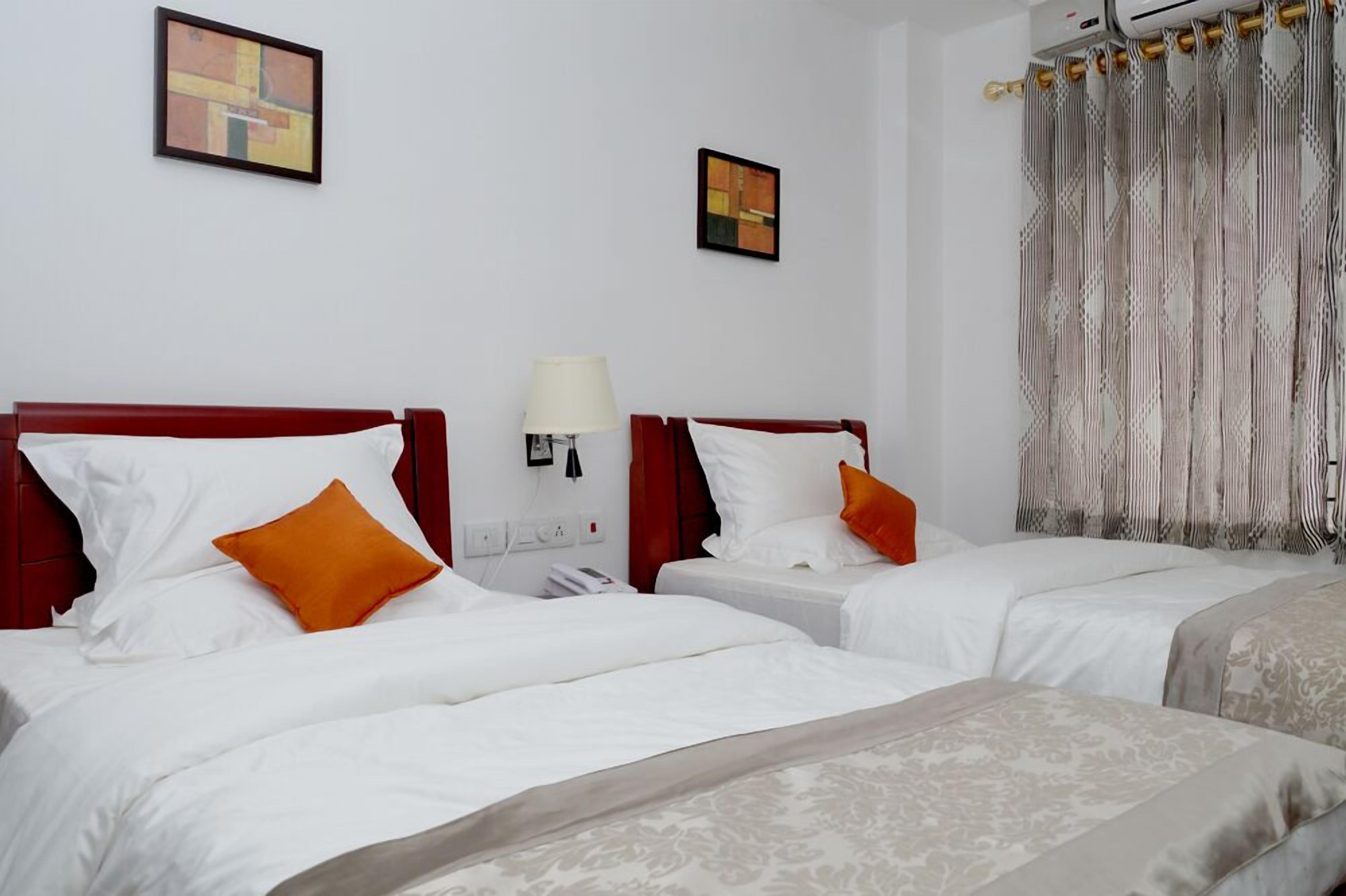 twin cot room with attached bathroom | premium bedding, in-room safe, desk, soundproofing