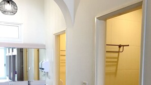 A modern bathroom with a white sink, mirror, and shower area. - MouMoon (Magong)