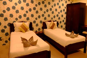Two single beds with wooden frames, white linens, and decorative pillows. - Alisa Krabi Hotel (Krabi)