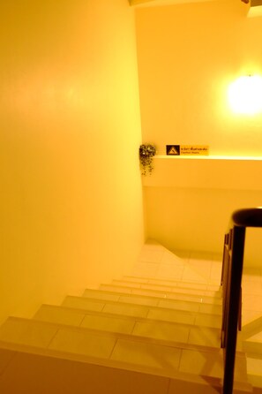 A staircase with a caution sign and a light fixture. - Alisa Krabi Hotel (Krabi)