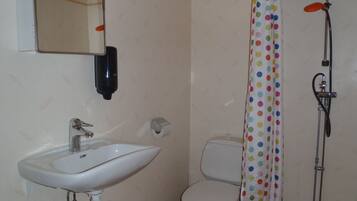 A bathroom with a sink, toilet, and shower.