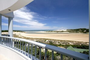 A balcony with a view of a beach and ocean. - The Oyster Box Beach House (Kenton on Sea)