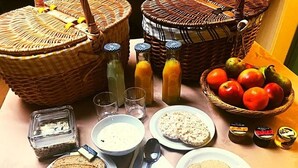 A table with various food items and utensils, including bread, cereal, fruits, and condiments. - TOR Rooms (Canterbury)