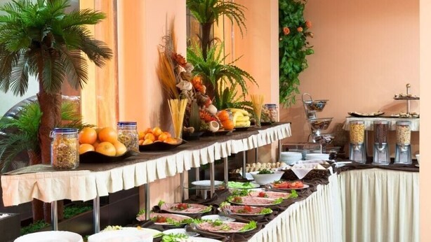 A buffet setup with various food items and decorations. - Apart Hotel Flora Residence (Samokov)