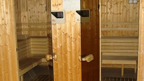 A sauna with wooden walls and benches. There are control panels on the wall. - Hotel Ela (Samokov)