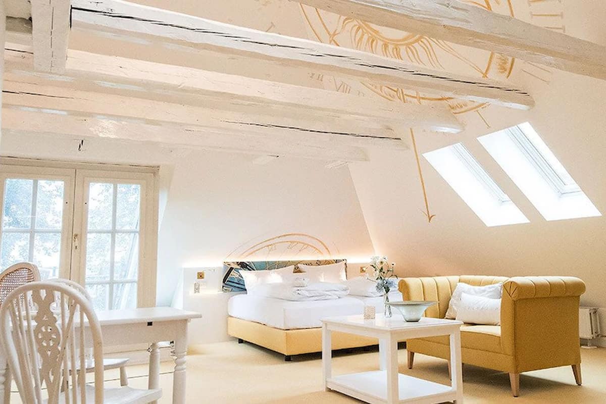 Junior suite (Sternstunden) | Luxe beddengoed, een minibar, een kluis op de kamer, een bureau