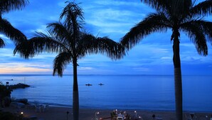 A beachside dining area with tables and chairs arranged in a heart shape, overlooking the ocean. - Malaika Beach Resort (Mwanza)