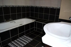 Deluxe Double or Twin Room, Pool View, Garden Area | Bathroom | Combined shower/tub, free toiletries, towels