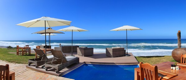 Una piscina al aire libre, sombrillas