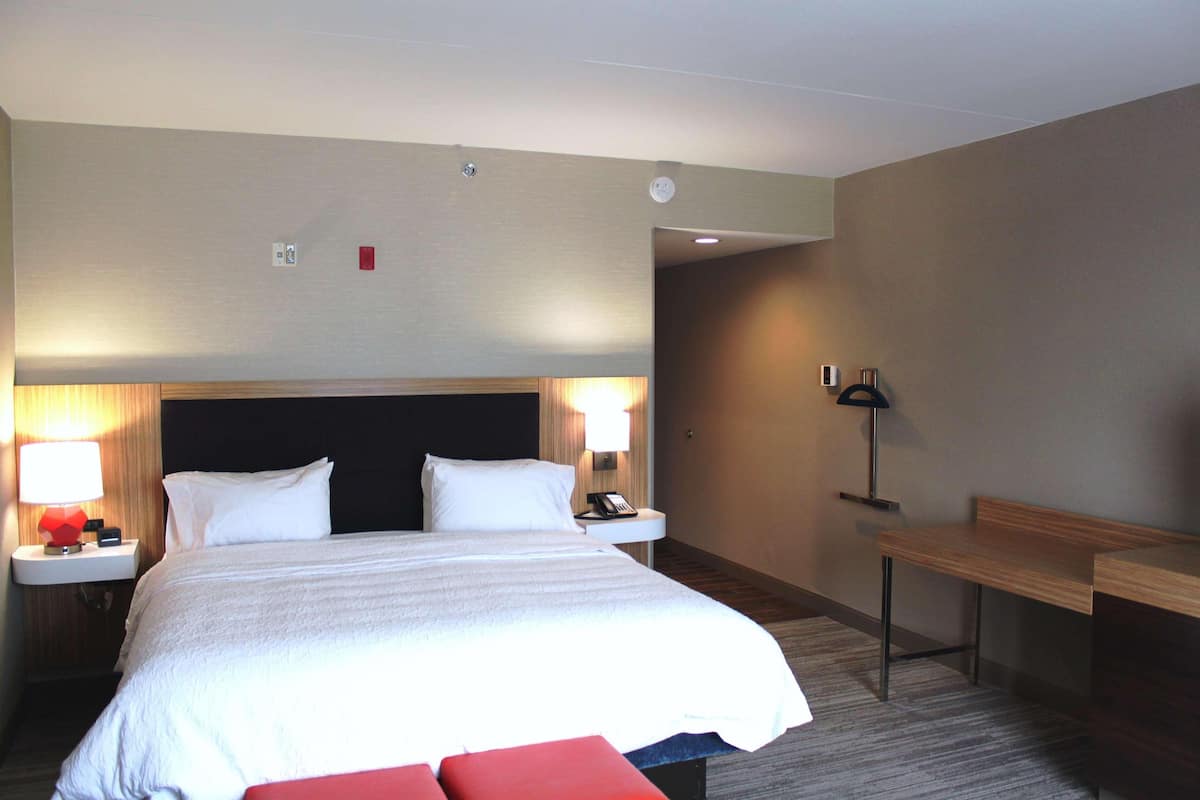 Premium bedding, desk, laptop workspace, blackout drapes