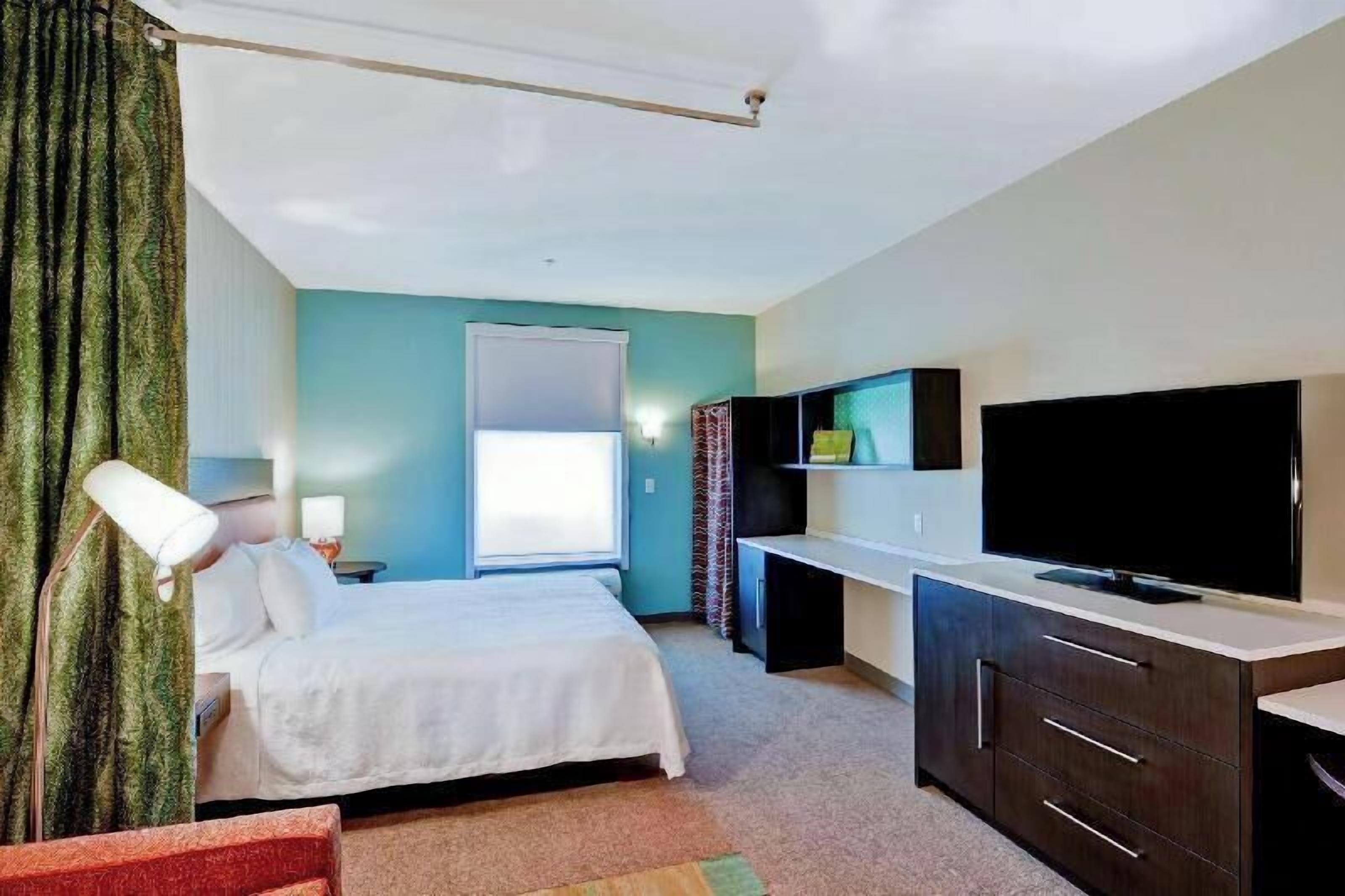 Desk, laptop workspace, blackout drapes, iron/ironing board