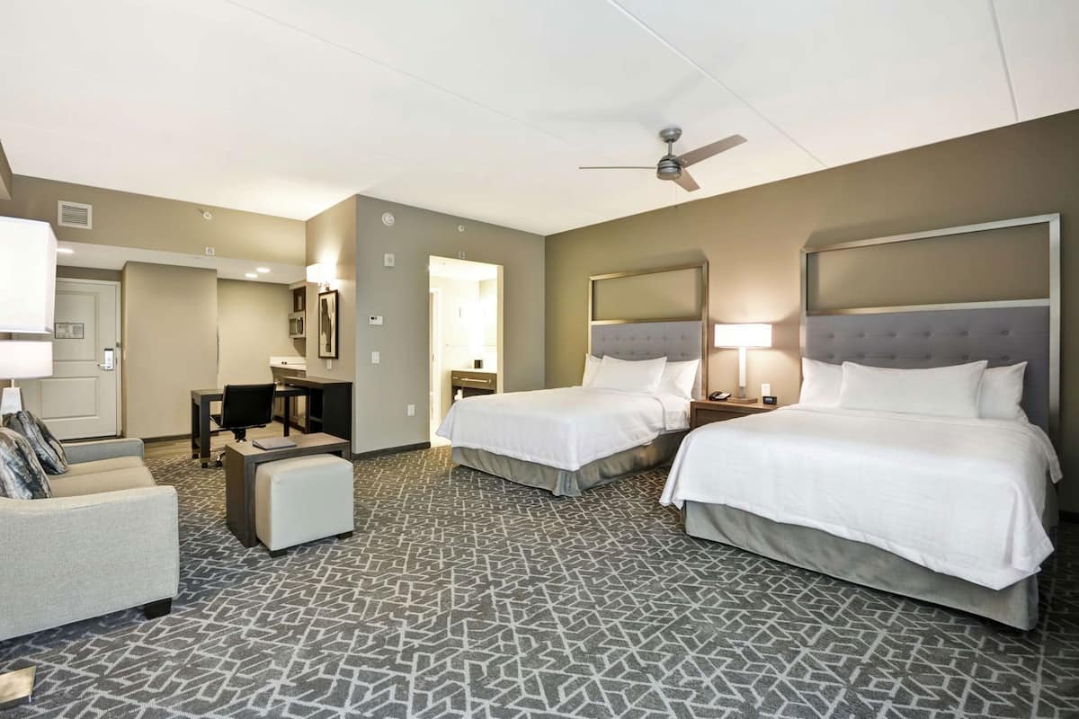 Hypo-allergenic bedding, desk, laptop workspace, blackout drapes