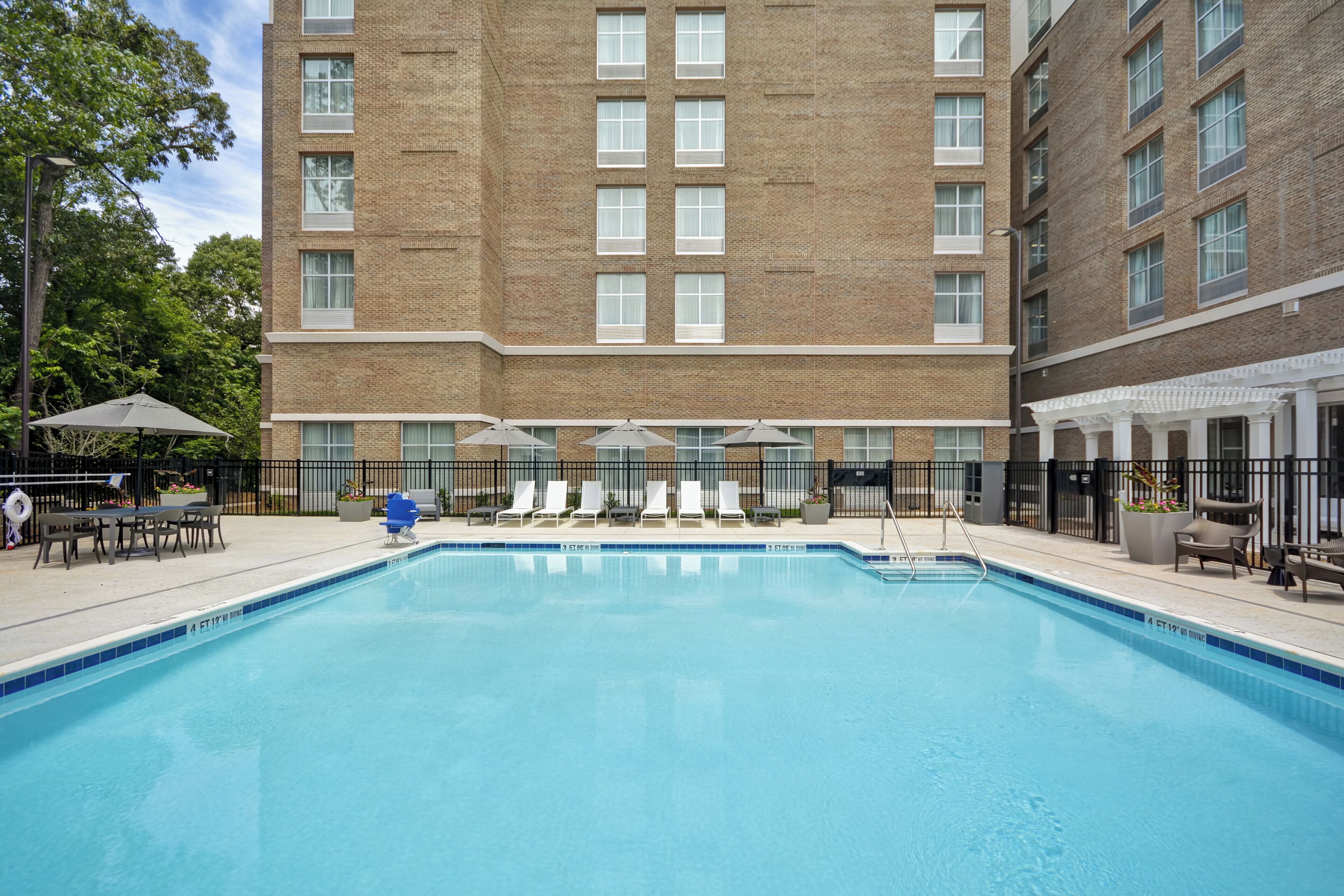 Seasonal outdoor pool, open 9:00 AM to 10:00 PM, pool umbrellas