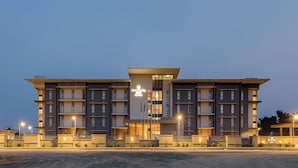 A modern hotel with multiple floors, a central entrance, and a well-lit facade. - Protea Hotel Owerri Select (Owerri)